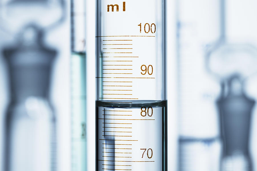 Meniscus. Curved surface (meniscus) of water in graduated cylinder. Liquid volume measured by reading the scale at the bottom of the meniscus. The reading is 82.6 mL Photograph by GIPhotoStock