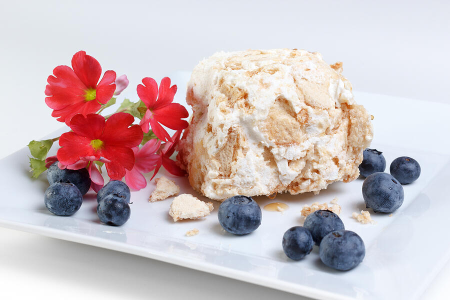 Meringue, sponge cake and blueberries dessert Photograph by ElOjoTorpe