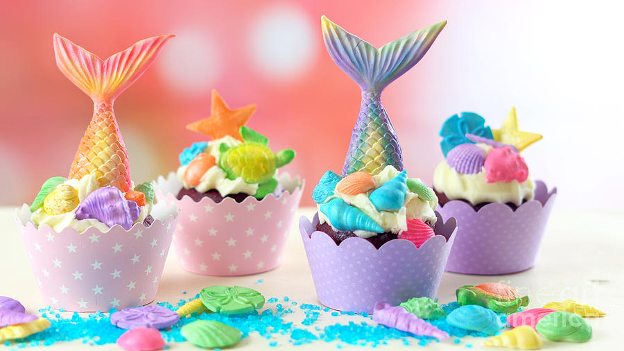 Mermaid theme cupcakes with colorful glitter tails, shells and sea creatures. Photograph by Milleflore Images