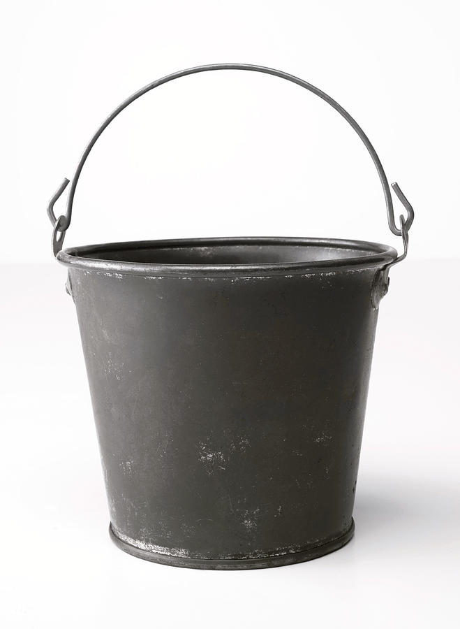 Metal bucket with an upright handle on a blank background Photograph by Rocksunderwater