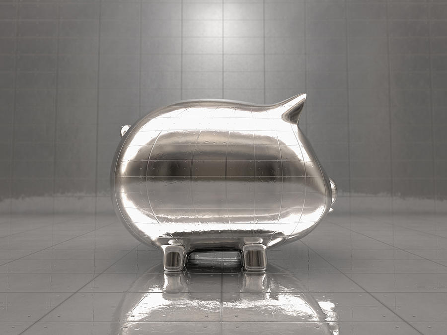 Metal piggy bank reflecting office walls Photograph by Colin Anderson Productions pty ltd
