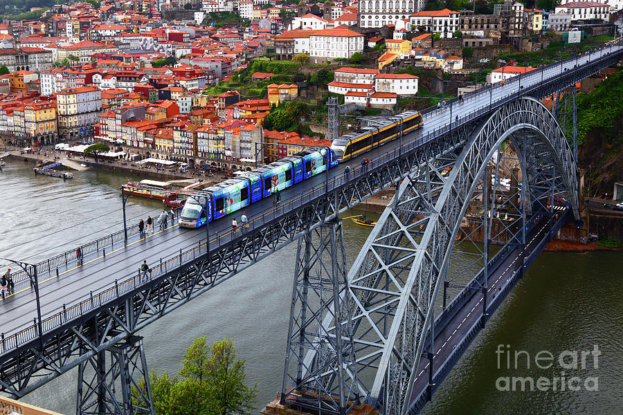 Metro train crossing the Dom Luis I Bridge Porto Portugal Photograph by James Brunker