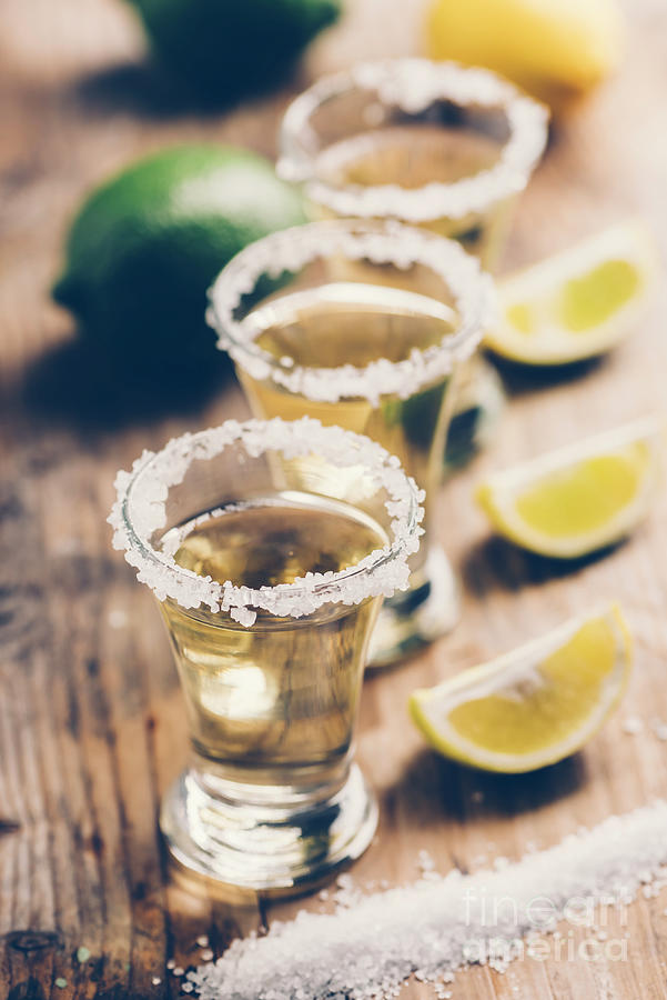 Mexican tequila with lemon on wooden table Photograph by Jelena Jovanovic