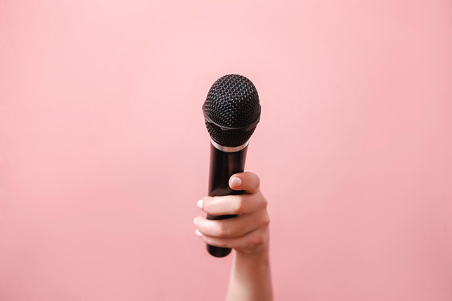 Microphone In Female Hand On Pink Background Photograph by Denis Valakhanovich Microphone In Female Hand On Pink Background Photograph by Denis Valakhanovich