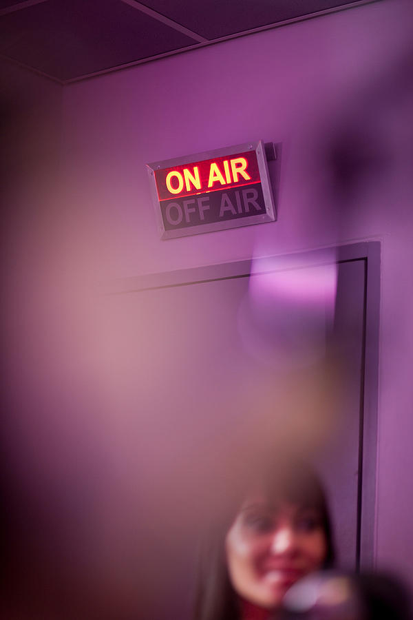 Mid adult woman in recording studio with illuminated sign Photograph by Zero Creatives