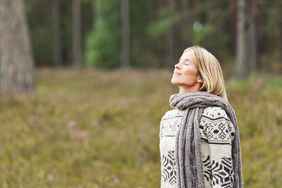 Mid adult woman wearing sweater with eyes closed Photograph by Nils Hendrik Mueller