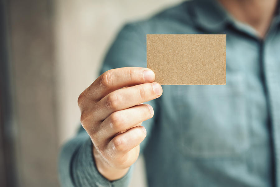 Mid-section of man holding business card Photograph by Sfio Cracho