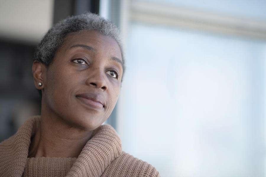 Middle Aged African Woman Reflecting stock photo Photograph by FatCamera