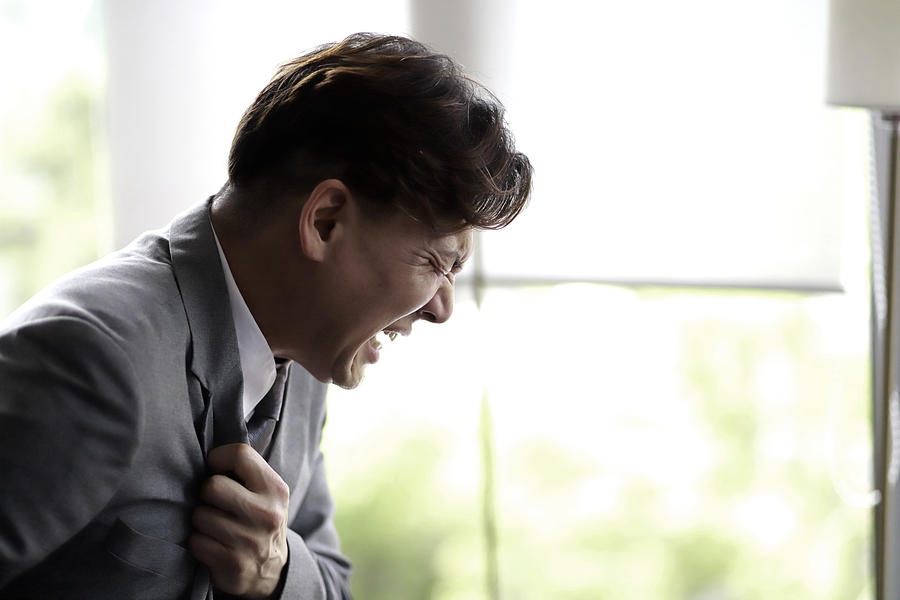 Middle aged businessman suffering from chest pain Photograph by Runstudio