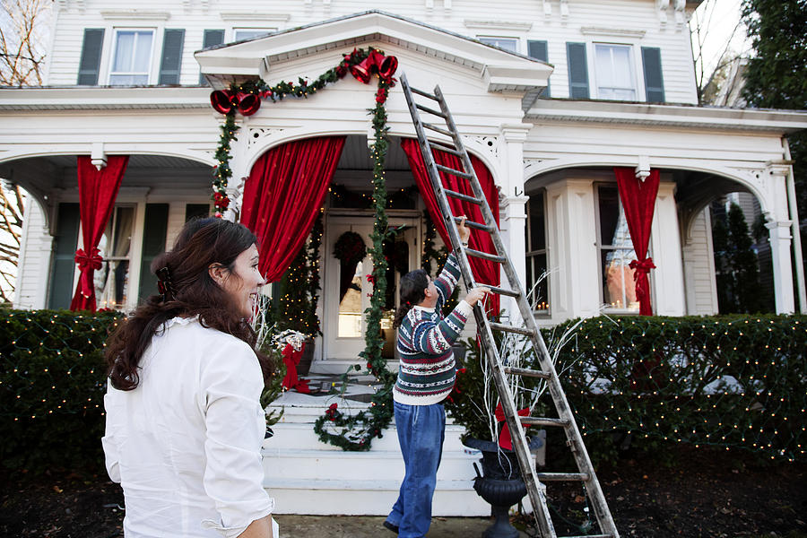 Middle aged couple decorating for the holidays Photograph by JodiJacobson