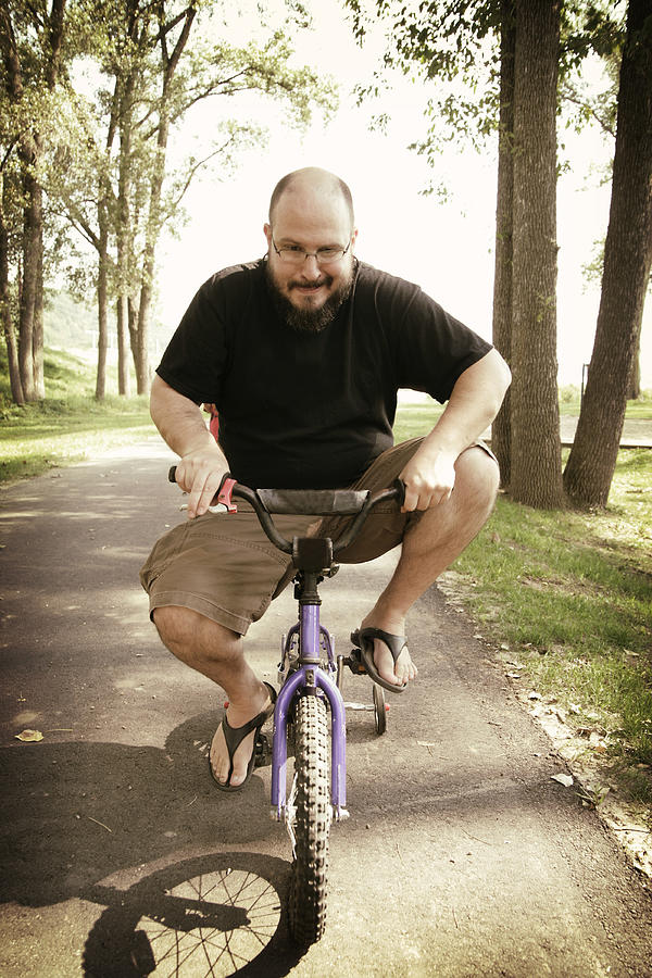 Middle Aged Man Rides Very Small Bicycle Photograph by ParkerDeen