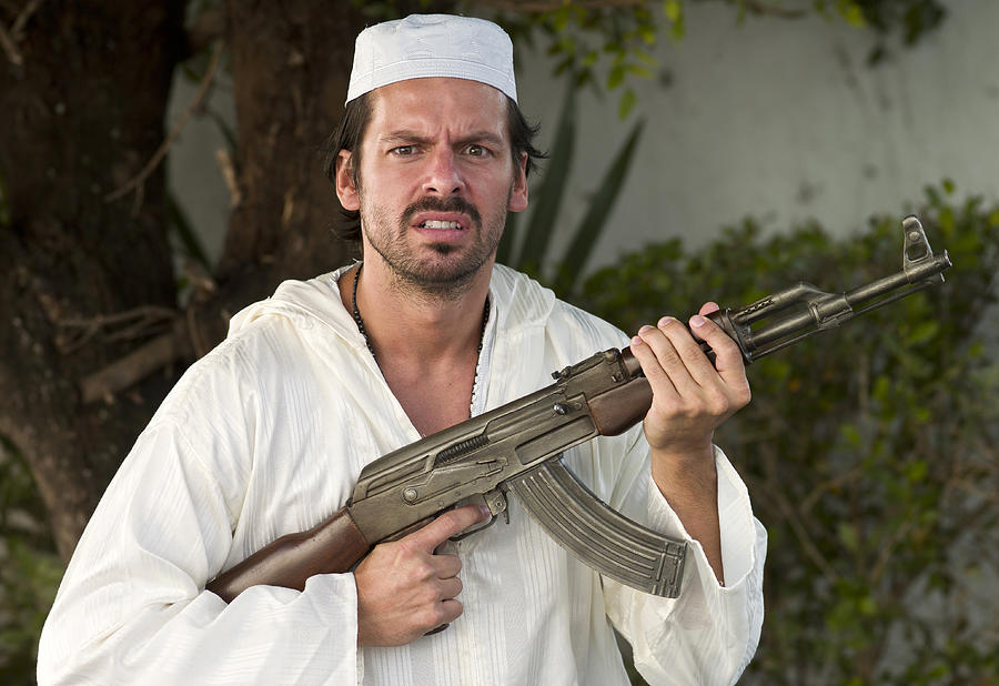 Middle Eastern Man Dressed in White and Armed with Gun Photograph by Juanmonino