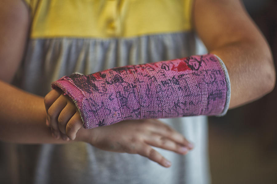 Midsection Of Girl Showing Her Signed Arm Cast Photograph by Rebecca Nelson