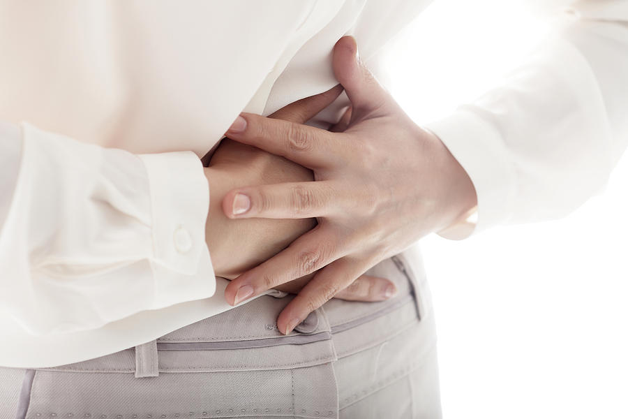 Midsection Of Woman Having Stomachache Photograph by Runstudio