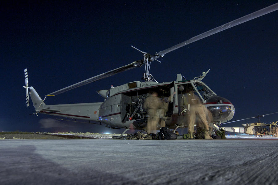 Military helicopter preparing for night-time mission from Kandahar, Afghanistan Photograph by Fotosearch