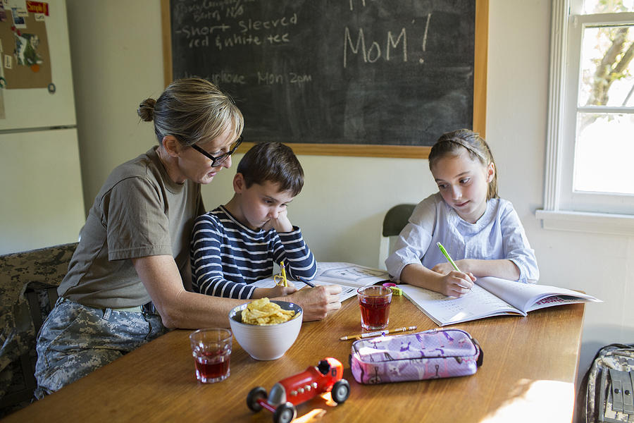 Military Mom helping her Children with Homework Photograph by Catherine Ledner