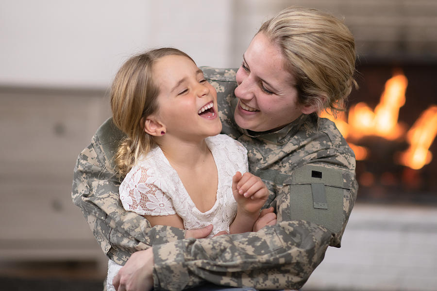 Military Mom Hugging Her Daughter Photograph by FatCamera