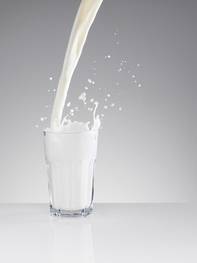 Milk splashing in full glass Photograph by Robert Daly