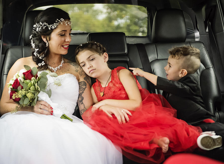Millennial bride in limousine on her way to wedding. Photograph by Martinedoucet