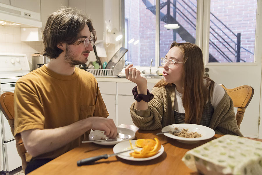 Millennial couple of students shared living at breakfast. Photograph by Martinedoucet
