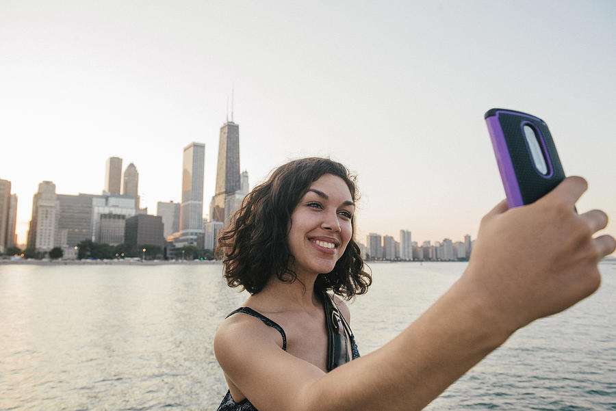 Millennial Hispanic Woman Takes Selfie at Chicago Skyline Photograph by Boogich
