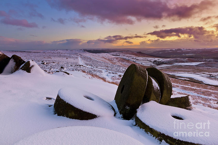 Millstones in snow at Sunset on Stanage Edge, Peak District, Derbyshire, England Photograph by Neale And Judith Clark