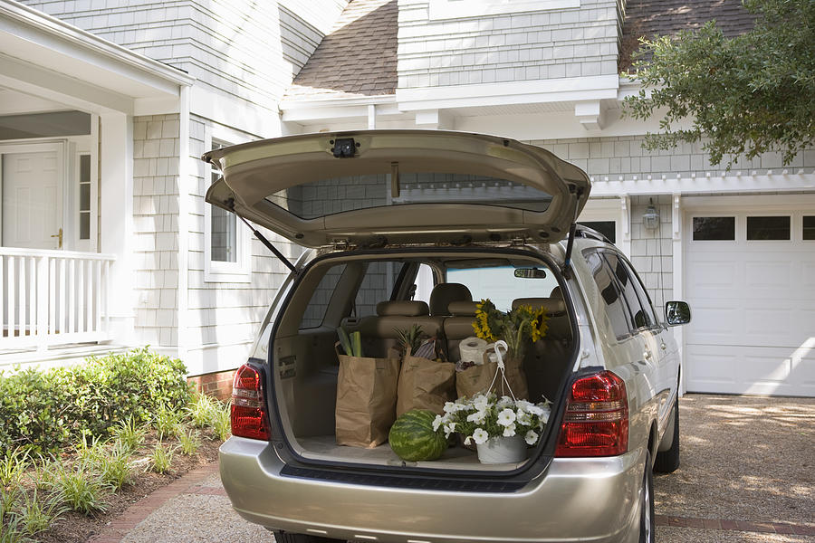 Mini-van with groceries and flowers Photograph by Comstock Images