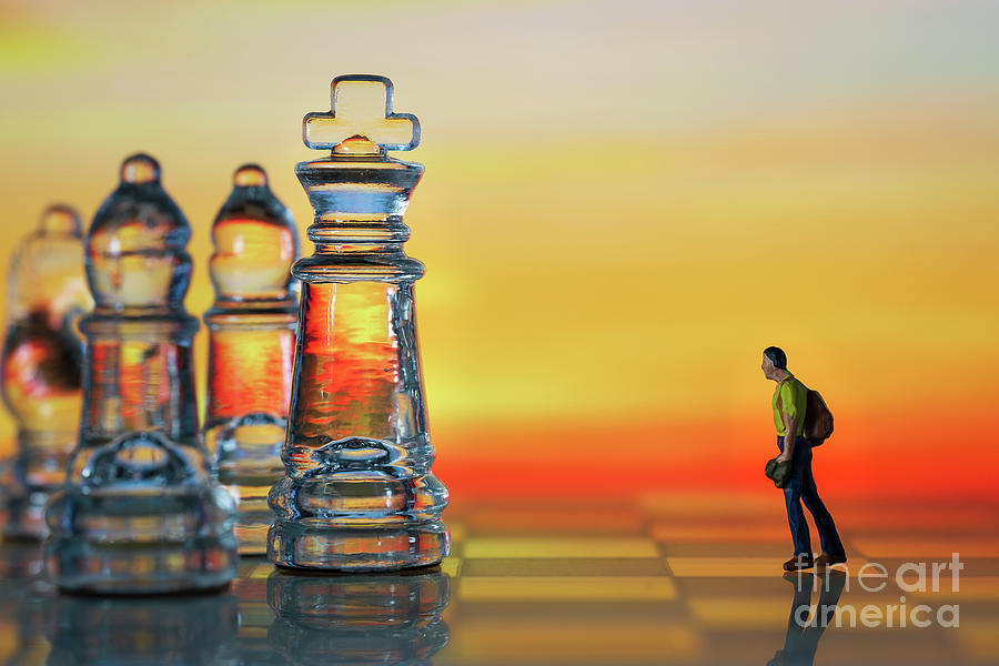 Miniature figure people as businessman standing face to face with King chess piece on chessboard. Sunset background. Macro Photograph by Pablo Avanzini