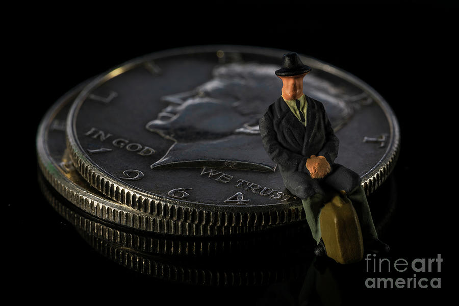 Miniature man seating on Half Dollar coin Black background Macro Photograph by Pablo Avanzini