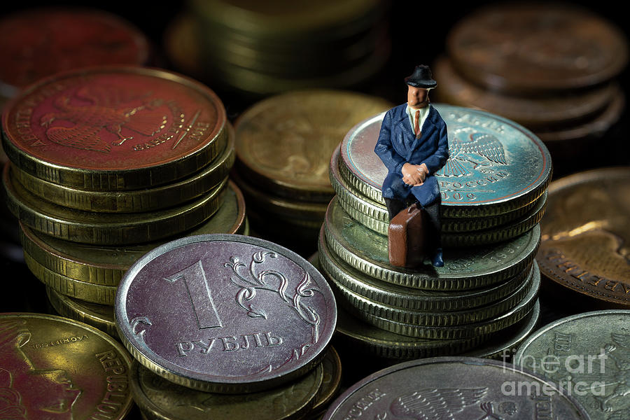 Miniature People. Businessman Sitting on Ruble coin stacks. Ruble devaluation inflation concept. Macro. Photograph by Pablo Avanzini