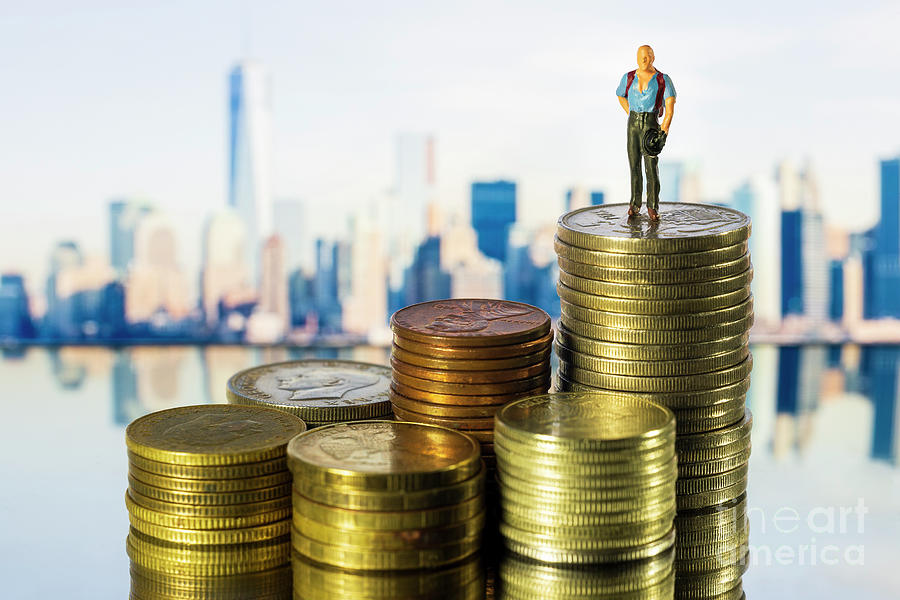 Miniature people Businessman standing on coin NY City Skyline Background. Success Concept. Macro Photograph by Pablo Avanzini