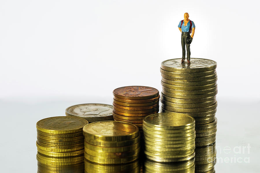 Miniature people Businessman standing on coin white background. Success Concept. Macro Photograph by Pablo Avanzini