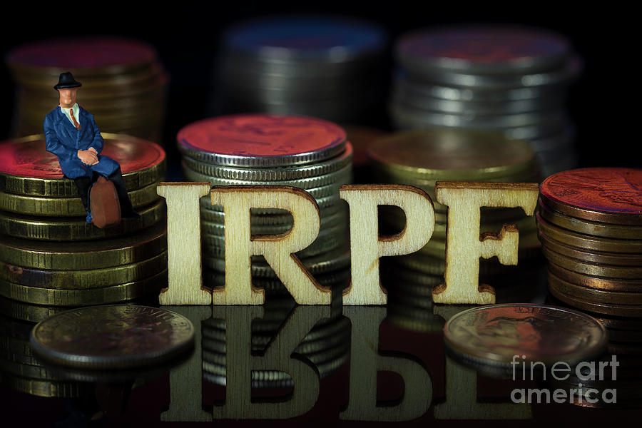 Miniature People. Man sitting on coin stacks with Text. IRPF Taxman Concept. Macro Photograph by Pablo Avanzini