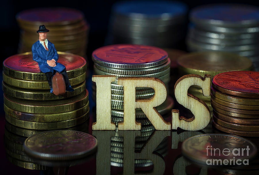 Miniature People. Man sitting on coin stacks with Text. IRS Taxman Concept. Macro Photograph by Pablo Avanzini