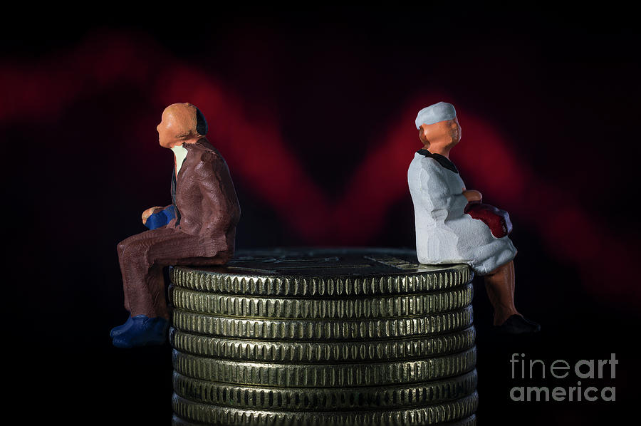 Miniature people. Senior old couple sitting on stack of coins. Red line plunge chart background. Pension inflation concept. Macro Photograph by Pablo Avanzini