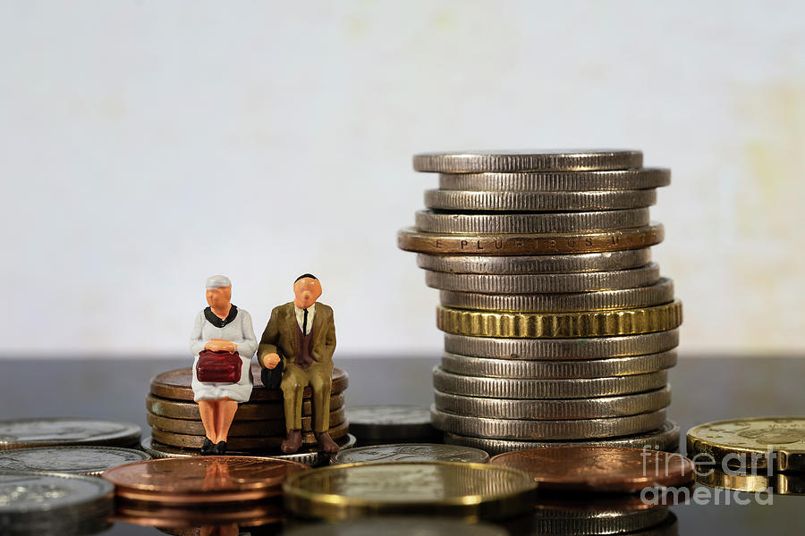 Miniature people seniors sitting on stack coins Photograph by Pablo Avanzini
