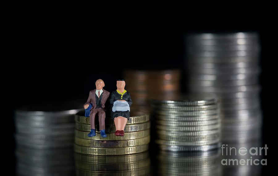 Miniature people seniors sitting on stack coins using as job retirement and insurance concept Macro Photograph by Pablo Avanzini
