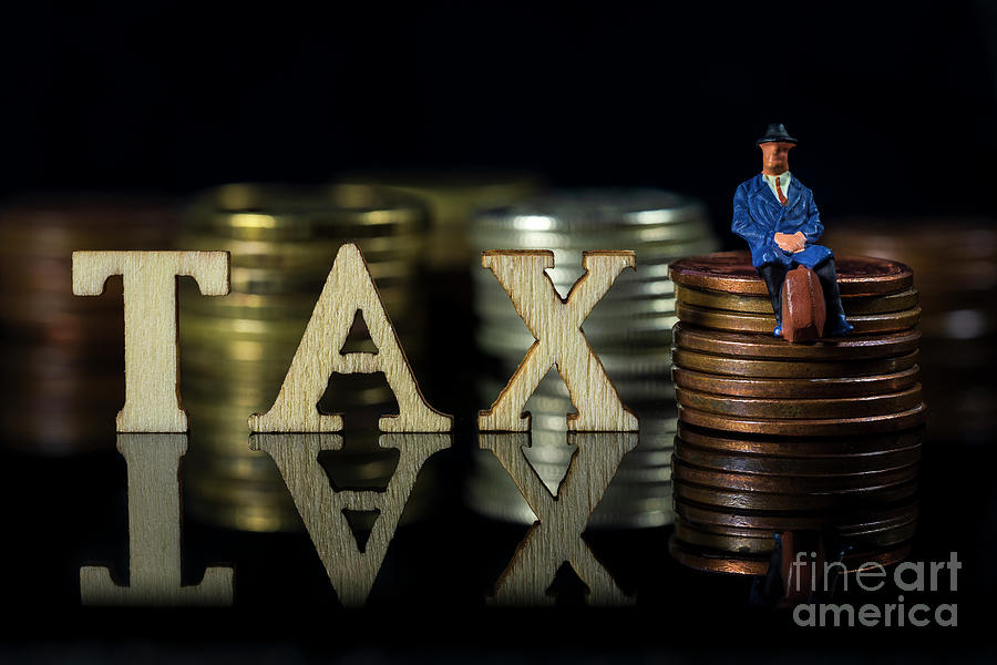 Miniature People. Tax concept.Word Tax and taxman sitting on stacked coins.. Macro Photograph by Pablo Avanzini