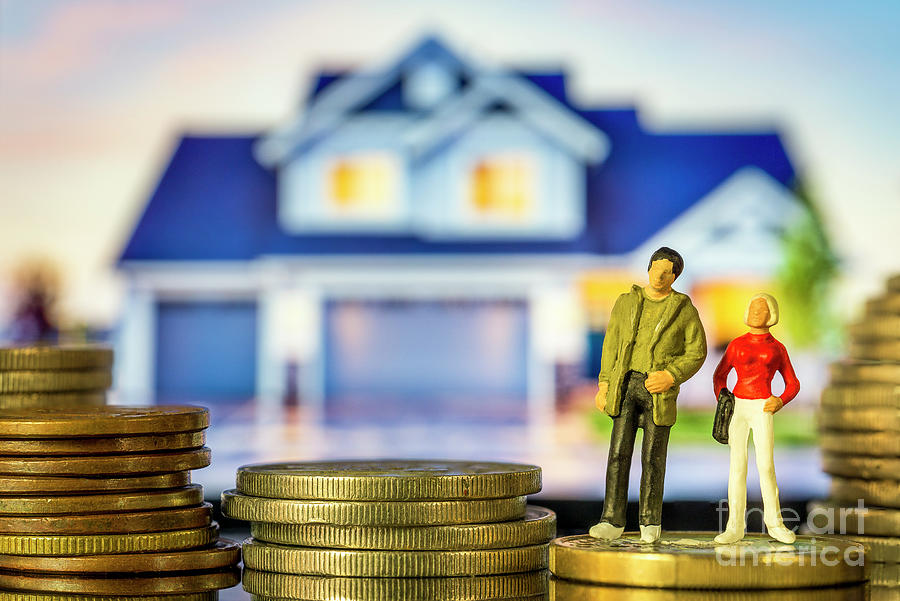 Miniature people Young couple standing on coin stack in front of house. Concept of home equity mortgage interest rates financial planning. macro Photograph by Pablo Avanzini