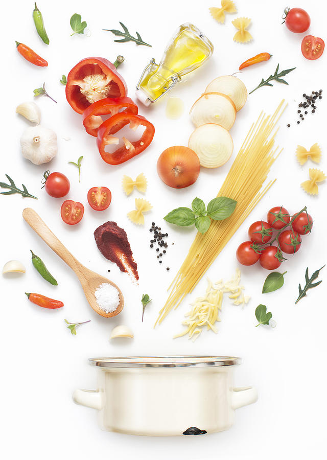 Minimalist style flat lay pasta recipe ingredients and cooking pot on white background. Photograph by Twomeows