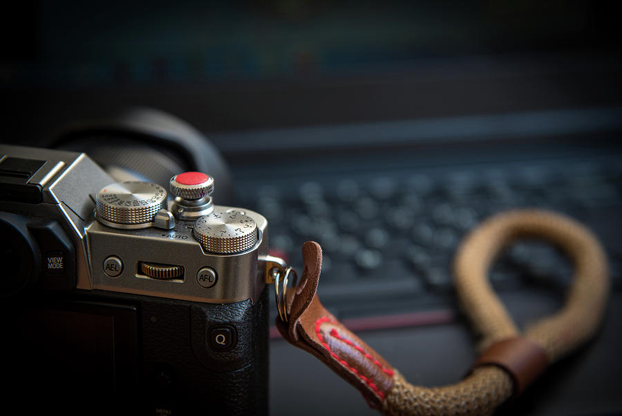 Mirrorless digital camera with control buttons , lens and strap Photograph by Michalakis Ppalis