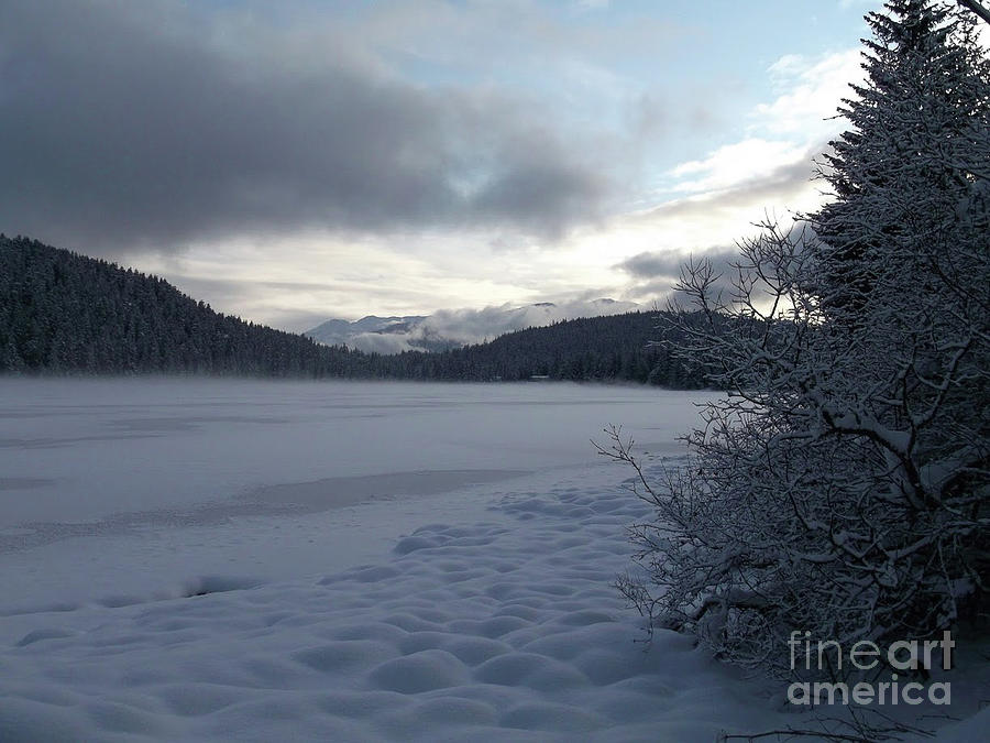Mist on a frozen lake Photograph by Charles Vice