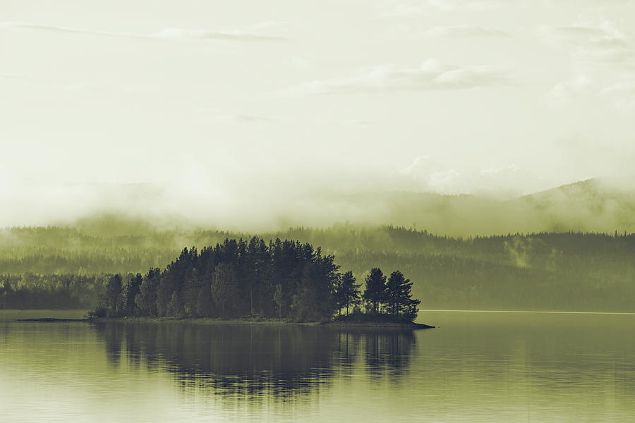 Mists are rising over a small wooded island in a glassy lake - d Photograph by Ulrich Kunst And Bettina Scheidulin