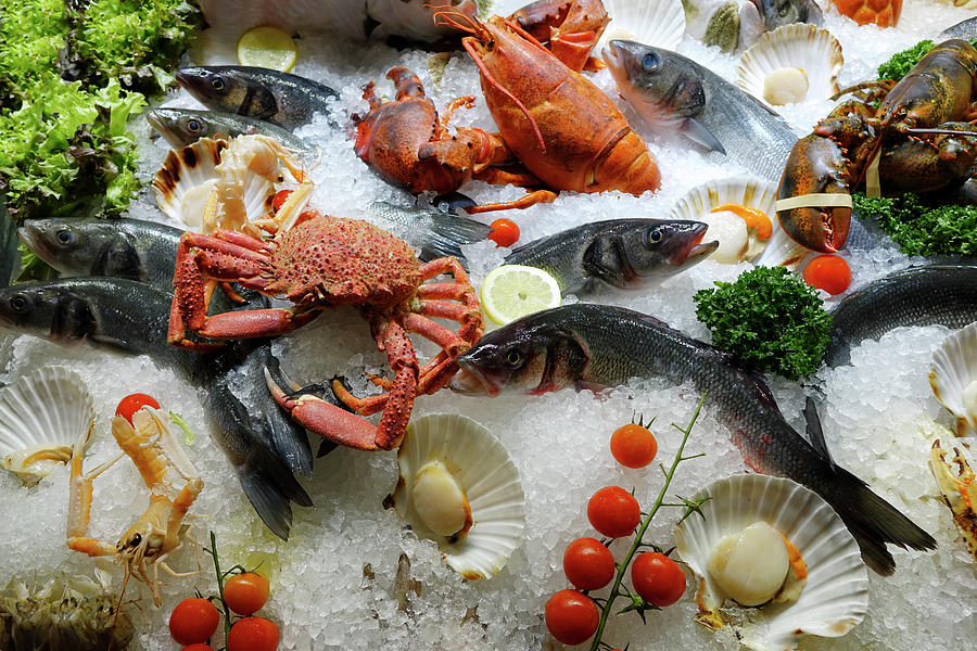 Mixed Fresh Raw Shellfish Seafood On Ice For The Market In Close Photograph