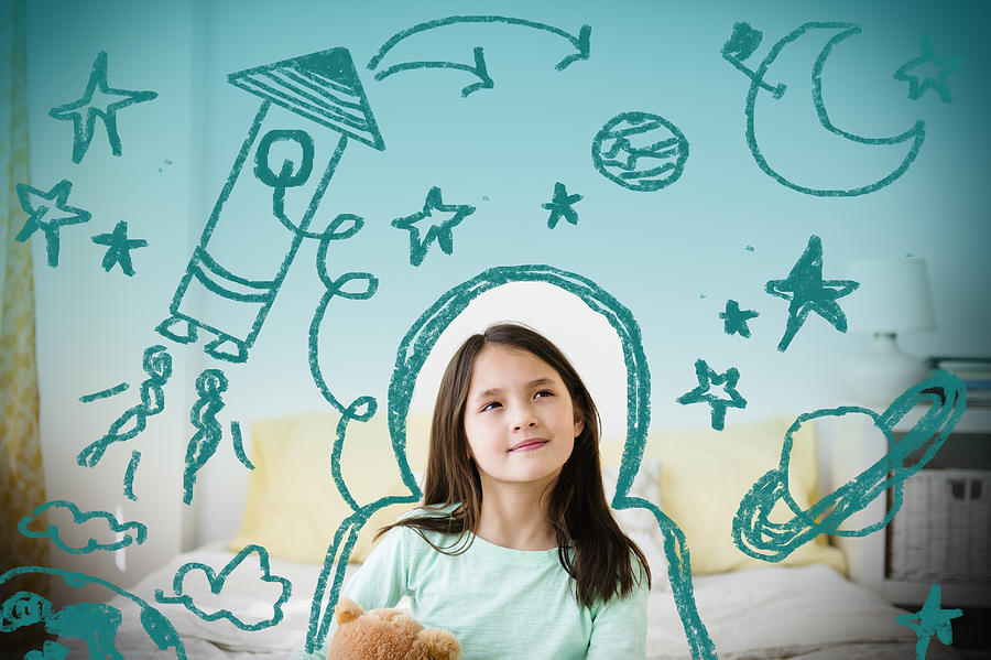 Mixed race girl with space doodles surrounding head Photograph by JGI/Jamie Grill