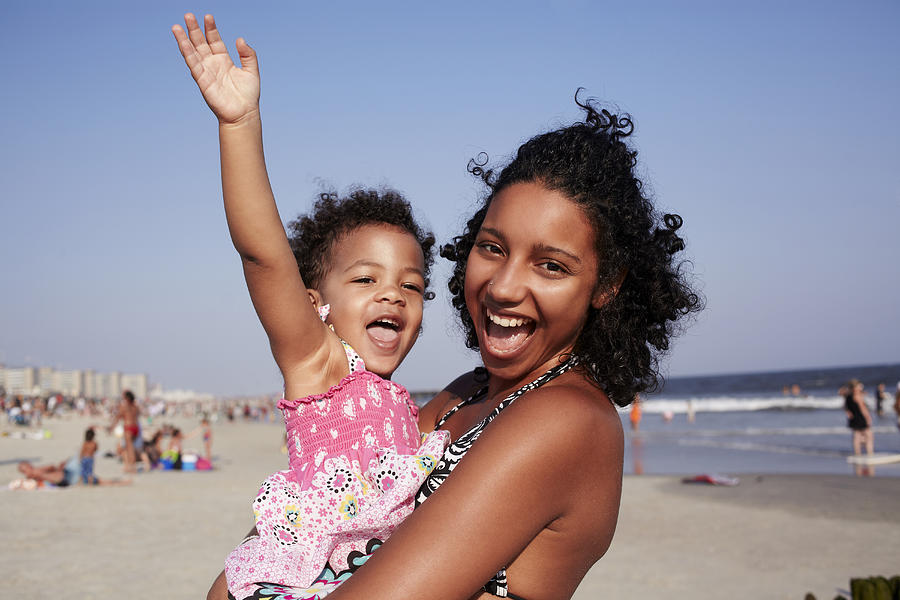 Mixed race mother and daughter enjoying the beach Photograph by Granger Wootz