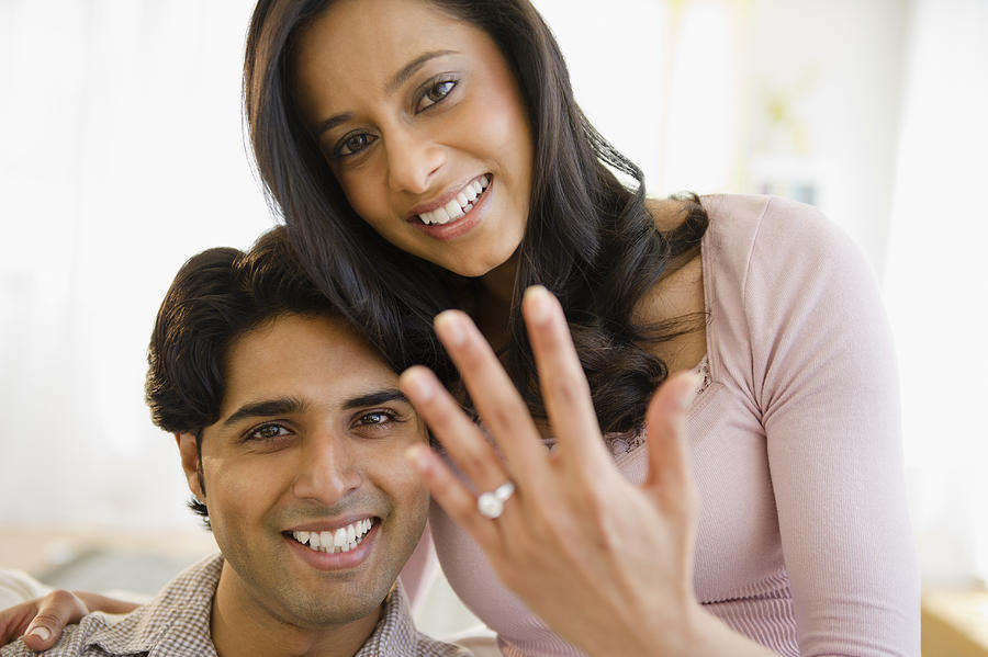 Mixed race woman showing off engagement ring Photograph by JGI/Jamie Grill
