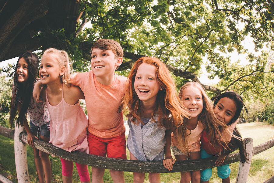 Mixed racial group of laughing children in a summer park Photograph by Wundervisuals