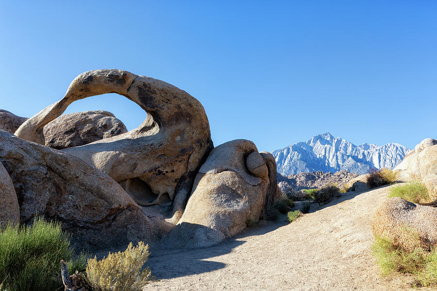 Mobius Arch and the Eastern Sierra Nevada Mountain Range in the  Photograph by Belinda Greb