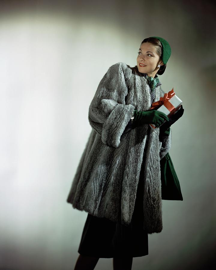 Model in Fur Carrying Gift Photograph by Constantin Joffe